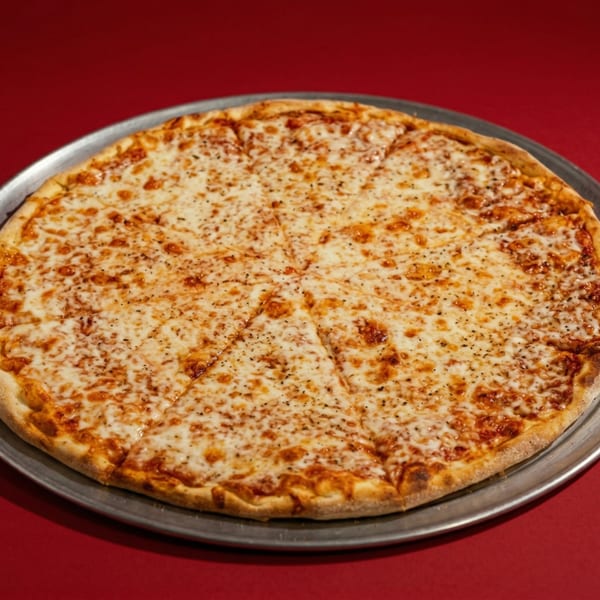 A whole cheese pizza, sliced into eight pieces, on a metal pan against a red background.